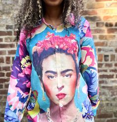 Our Frida in the Garden Button-up Blouse is perfect for channeling your inner Frida Kahlo in style! Light and breezy, this unique top features an artwork of the iconic artist, surrounded by a lively garden of birds - the perfect look for any day you want to feel like spring! Get ready to rock this beautiful blouse and make a bold statement! Product Details Material: Polyester fiberFit: Loose fit (like a shacket) *size small in the photosCare: Machine wash cold, hang to dryShipping: Imported (est Bohemian Multicolor Button-up Shirt, Multicolor Vibrant Print Button-up Top, Multicolor Vibrant Print Button-up Shirt, Multicolor Vibrant Print Button-up Blouse, Multicolor Abstract Print Button-up Blouse, Photo Care, Unique Top, Beautiful Blouses, In The Garden