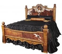 the bed is made up with black sheets and gold trimmings on it's headboard