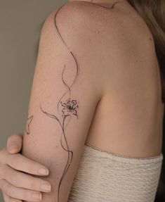 a woman with a flower tattoo on her arm