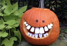 a pumpkin with teeth and fangs on it