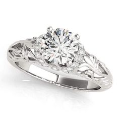 a white gold engagement ring with an intricate design