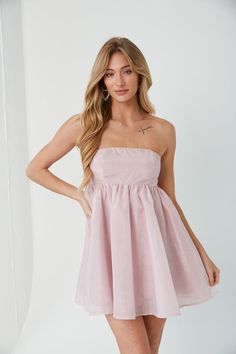 Be the life of the party in the Bella Strapless Babydoll Mini Dress! This gorgeous mini dress is fully lined with an organza overlay. Available in blush pink, blue, blue floral, black, and white. Pair with some cowboy boots for a trendy take on a classic style! Details 100% Polyester Silicon grips Hidden back zipper Hand wash cold / hang dry Runs large for our standard sizing. Order down. Edgy Cardigan, Bat Mitzvah Dress, Strapless Babydoll Dress, Pink Babydoll Dress, Bat Mitzvah Dresses, Organza Overlay, School Dance Dresses, 4 Birthday, Desired Reality