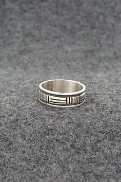 This sterling silver ring was made by Navajo silversmith Bruce Morgan. The inside is signed B Morgan and stamped sterling.Size: 7.5Length: 1/4"Free shipping on all orders! We ship with USPS and always include tracking. All orders ship within a day of payment.Returns are accepted up to 30 days after you receive your order. Just send us a message. Our shop offers cash back or store credit. The item must be returned in new condition. Artisan Engraved Sterling Silver Ring 925, Artisan Sterling Silver Ring With Etched Details, Artisan Sterling Silver Etched Rings, Sterling Silver Engraved Wide Band Ring, Silver Southwestern Style Rings, Southwestern Style Untreated Silver Rings, Southwestern Sterling Silver Rings For Anniversary, Sterling Silver Etched Ring With Round Band, Etched Sterling Silver Round Band Ring