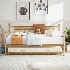 a bed with two pillows and a teddy bear sitting on top of it in a bedroom