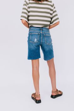 Get ready for a summer to remember with these playful high rise denim shorts. The rips and fraying at the bottom add a touch of edge and uniqueness, making these shorts a staple for any summer wardrobe. (Plus, they'll keep you looking cool while staying cool!) Details High rise fit Denim Rips/fraying at the bottom Sizing Approximate measurements: SIZE LENGTH/INSEAM WAIST Small 18/11" 30" Medium 19/11" 32" Large 19/11" 34" Fabric has stretchModel is 5’8 wearing small Material 97% Cotton 2% Elaste A Summer To Remember, Summer To Remember, High Rise Denim Shorts, High Rise Denim, Summer Wardrobe, Get Ready, Denim Shorts, Summer Fashion, High Rise