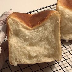 two loaves of bread sitting on top of a cooling rack