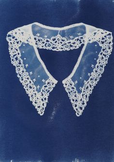 an image of a blue and white cloth with lacy trims on it's edges