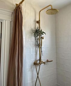 a shower head and hand held shower faucet in a bathroom with white tile walls