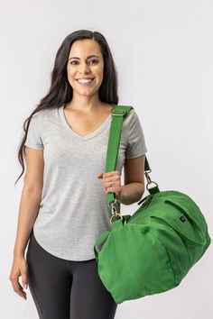 Nothing beats the simplicity and functionality of a good duffle bag—except maybe our Bumi Eco Duffel Bag, made with the good of the environment and people in mind! The perfect size for a spontaneous weekend getaway or when you need a little more room to haul daily gear for work or athletics.  Bag: 13"(H) x 20"(W) x 12"(D) Made with 12 to 14 oz Certified Fairtrade Organic cotton canvas Approximately 56L capacity Main compartment zippers with long pulls Internal zippered hanging pocket sized 9” (H Everyday Satchel Duffle Bag With Pockets, Practical Duffle Bag Tote With Pockets, Practical Duffle Bag Shaped As Tote With Pockets, Practical Weekender Bag With Adjustable Strap, Functional Green Duffle Bag For Daily Use, Everyday Duffle Bag With Pockets, Everyday Practical Duffle Bag With Adjustable Strap, Green Duffle Bag With Adjustable Strap For Daily Use, Practical Everyday Shoulder Duffle Bag