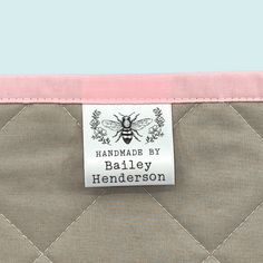 a label on the side of a bag with a pink border around it that says handmade by bailey henderson