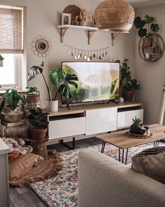 a living room filled with furniture and plants