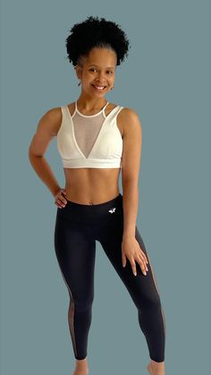 a woman is posing for the camera in her sports bra top and leggings