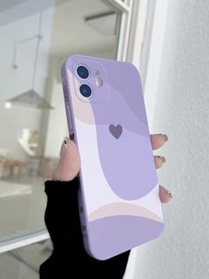 a person holding up a phone case with a heart on the front and back side