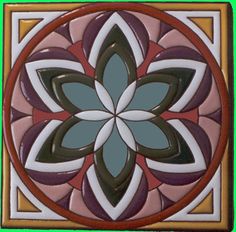 an artistic tile design in brown, pink and green colors with a circular flower on the center