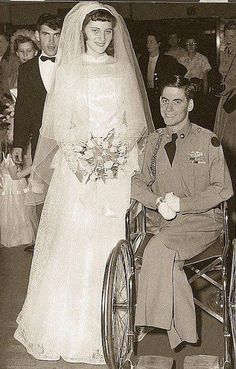 an old black and white photo of a man in a wheelchair next to a bride