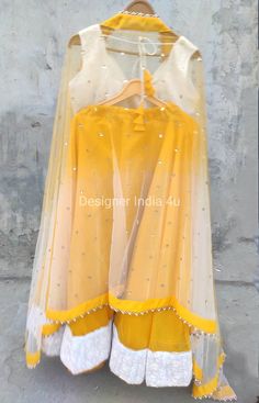 This is Custom Made Yellow Chanderi Silk Wedding Party Wear Lehenha Blouse Dupatta. Fabric and work: Lehenga made using Chanderi Silk fabric with thread work white border attached at border. Blouse is made using threadwork fabric. Dupatta made using Sequines Net. Post your order we will send you a measurements form and you will need to let us know your size details accordingly. I make it exclusively for my customers by using designer high quality fabrics. I will only make it after you confirm yo Yellow Dori Work Dress For Navratri, Yellow Dori Work Dress For Festivals, Traditional Yellow Skirt For Festive Occasions, Yellow Organza Salwar Kameez With Traditional Drape, Designer Yellow Anarkali Set With Unstitched Blouse, Festive Yellow Anarkali Set With Unstitched Blouse, Bollywood Style Yellow Lehenga With Unstitched Blouse, Yellow Sets With Sheer Dupatta For Diwali, Yellow Art Silk Anarkali Set With Unstitched Blouse