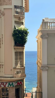 an apartment building next to the ocean with a balcony and balconies on it