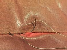 a close up of a piece of leather with some thread on the inside of it