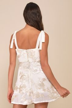 Everyone you meet will be instantly charmed by your style, thanks to the Lulus Truly Inspiring Ivory Mesh Floral Applique Tie-Strap Mini Dress! A sheer mesh overlay (atop a matching knit liner) features trendy three-dimensional floral appliques throughout as it shapes this sweet dress that features a sleeveless bodice, a sleek straight neckline, and long slender straps that tie at the shoulders. The high, fitted waist tops a breezy, skater-style skirt that finishes at a flirty mini hem. Hidden back zipper/clasp. Fit: This garment fits true to size. Length: Mid-thigh. Bust: Great for any cup size. Waist: Loosely Fitted. Hip: Not Fitted - room for hips. Undergarments: May be worn with a strapless bra, adhesive bra, petals, or no bra. Fabric: Fabric has some stretch. Lined. Shell: 93% Polyest Beige Party Dress With Tie Straps, Chic White Dresses With Delicate Straps, Chic White Dress With Delicate Straps, Summer Wedding Dresses With Straps, Fitted Cream Dress With Adjustable Straps, Cream Fitted Dress With Adjustable Straps, Cream Summer Dress With Adjustable Straps, Beige Sleeveless Dress With Delicate Straps, Beige Party Dress With Adjustable Straps