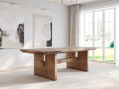 a large wooden table sitting in front of a window next to a painting on the wall