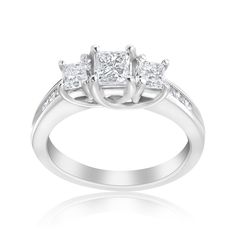 a three stone diamond ring with four princess cut diamonds on the shoulders and side stones, set in 18k white gold