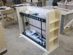 an assembly area with shelves and tools in it