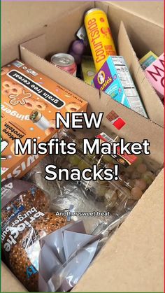 an open box filled with snacks on top of a wooden table and the words new misfits market snacks