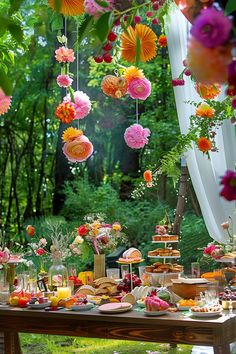 the table is covered with flowers and desserts for an outdoor wedding or bridal party