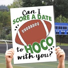 a person holding up a sign that says, can i score a date to hoco with you?