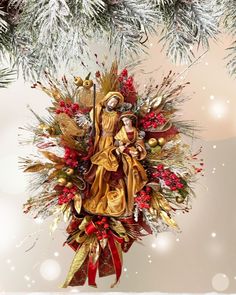 an ornament hanging from a christmas tree with red and gold decorations on it