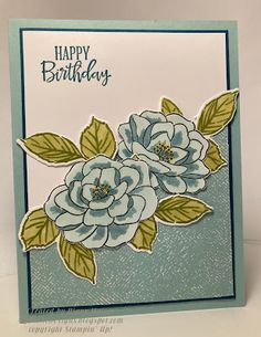 a birthday card with blue flowers and green leaves