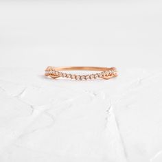 a rose gold ring with diamonds on it