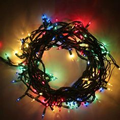 christmas lights are arranged in a circle on the wall, all lit up and ready to be used