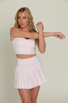 Our 15" Pearl Pink Pleated Tennis Skirt - is our famous pleated tennis skirt, now in a longer length of 15". The skirt features built-in spandex shorts that include a comfortable fit and side pockets for storage. This exclusively designed Gold Hinge skirt is made of quick dry material and can take on any activity such as golf, tennis, running and more. Fitted Pleated Tennis Skirt For Workout, Summer Sports Pleated Tennis Dress, Summer Sports Tennis Dress With Pleats, Pleated Stretch Skort For Athleisure, Pleated Stretch Athleisure Skort, Stretch Pleated Skirt For Sports, Spring Season, Athleisure Pleated Stretch Skort, Sporty Pleated Tennis Skirt For Workout, Stretch Pleated Workout Bottoms