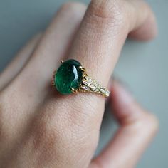 Read about our payment plans before proceeding.This is what dreams are made of. This emerald ring features an insanely gorgeous deep green natural cabochon emerald stone, embellished with 57 natural white diamonds with details like phoenix wings. A classy and sleek ring to treasure forever. Handcrafted in your choice of 14K yellow gold, rose gold, and white gold. The emerald shown is the exact same emerald you will receive. 14K solid gold Natural 12*9mm natural cabochon emerald. Approx. 2.8ct~. Luxury Oval Emerald Birthstone Ring, Fine Jewelry Emerald Ring With Oval Cabochon, Fine Jewelry Emerald Oval Cabochon Ring, Emerald Oval Cabochon Ring As A Gift, Fine Jewelry Emerald Green Oval Cabochon Ring, Yellow Gold Emerald Ring With Oval Cabochon, Yellow Gold Emerald Ring Oval Cabochon, Green Oval Cabochon Emerald Ring, Elegant Emerald Ring With Cabochon Cut