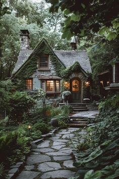 a stone path leading to a house in the woods