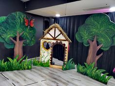 an indoor play area with painted trees and a dog house