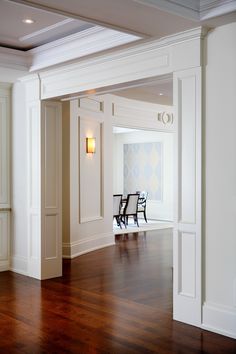 an empty room with white walls and wooden floors