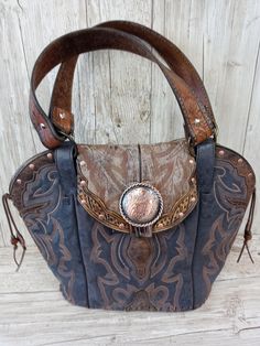 Double Cowboy Boot Purse Hand-Crafted from a Pair of Boots Tote Style (no pockets) No Two Alike Leather Body/Leather straps Western concho Leather Base Magnetic Closure Measures approx. 10"x12" FAQ's  Reviews Western Leather Purse, Best Cowboy Boots, Boot Purse, Cowboy Boot Purse, Hipster Purse, Statement Purse, Handmade Leather Purse, Western Handbags, Cowgirl Chic