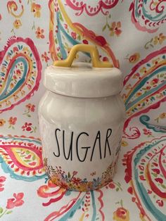 a ceramic sugar jar with the word sugar on it