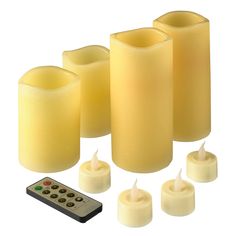 candles and remote control on white background