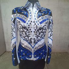 a mannequin with blue and white designs on it's body, standing in front of a wall