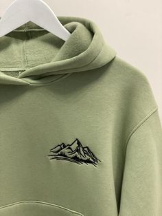 Embroidered Mountains hoodie, sweatshirt, and t-shirt for Gift.It's an original and creative idea of the present for Traveler Lover Fan.------------------------------------------------------• HOODIE/SWEATSHIRT •Material:∘ 70% cotton∘ 30% polyesterSize:∘ women: S, M, L∘ man:S, M, L, XL, XXLColors:∘ women: black, white, pink, light green, beige, blue wave, melange∘ man: black, white, beige, melange, khaki------------------------------------------------------• T-SHIRT •Material:∘ 95% cotton∘ 5% ela Green Long Sleeve Hoodie With Embroidered Graphics, Green Embroidered Long Sleeve Hoodie, Green Crew Neck Hoodie With Embroidered Graphics, Winter Hoodie With Embroidered Logo And Crew Neck, Winter Crew Neck Hoodie With Embroidered Logo, Winter Embroidered Logo Crew Neck Hoodie, Winter Hoodie With Letter Embroidery And Relaxed Fit, Winter Crew Hoodie With Letter Embroidery, Crew Hoodie With Letter Embroidery For Winter