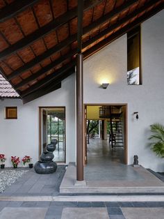 the entrance to a modern house with stone steps