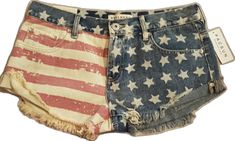 Casual Blue Shorts For 4th Of July, Casual Cotton Jean Shorts For 4th Of July, Casual American Flag Bottoms For 4th Of July, Americana Style Denim Jean Shorts For Spring, Casual Flag Print Jean Shorts For Summer, Trendy Cotton Jeans For 4th Of July, Casual Flag Print Jean Shorts For Spring, Casual Blue Jean Shorts With American Flag Print, Cutoff Cotton Shorts For 4th Of July