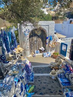 an outdoor market area with blue and white items on display, including vases and plates