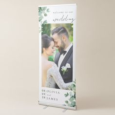 a wedding photo on a roll up banner with the words welcome to our newly married couple