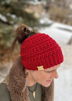 "Beautifully hand crocheted women's messy bun/ponytail hat. Open top for your high ponytail or bun. Snug fit to make it warm and cozy, with a slightly bohemian look, to match all your outfits. Faux leather tag, easy-care 100% acrylic yarn. Machine washable on cold. Sized to fit an average adult's head with a 21\" - 22' circumference. Color may vary slightly from photograph. Pattern: Crocheted Katniss Messy Bun Beanie by Bell@ Haken&ZOO" Messy Bun Ponytail, Bun Ponytail, Bun Beanie, Messy Bun Beanie, Messy Bun Hat, Bun Hat, Ponytail Hat, Crochet Winter, High Ponytail