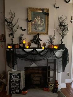 a fireplace decorated for halloween with candles and decorations