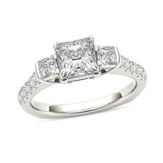 a princess cut diamond engagement ring with shoulder stones on the sides and shoulders, set in white gold